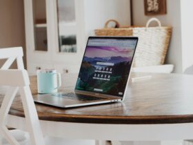 MacBook on Brown Wooden Table